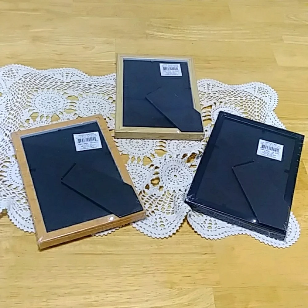 Three small picture frames, new in plastic
